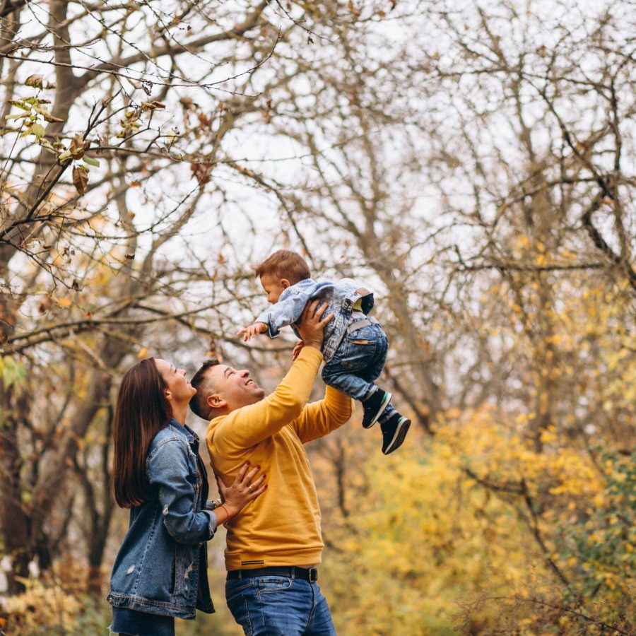 Family with a little son in autumn park